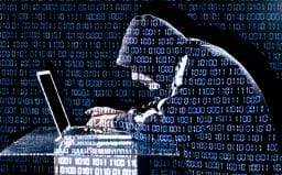hacker-with-code-superimposed-image-from-shutterstock