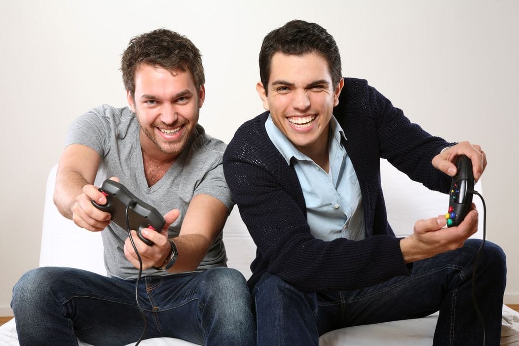 Men playing. Мужчина, играющий сразу на нескольких устройствах. Two man playing videogames.