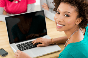 young woman in front of macbook Pro, image from Shutterstock