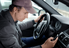 man-texting-in-car-image-from-shutterstock