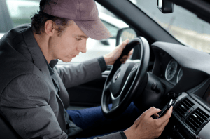man-texting-in-car-image-from-shutterstock