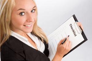 Image of woman holding a checklist, image from Shutterstock