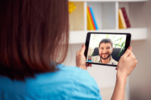 Woman video chatting with man, image from Shutterstock