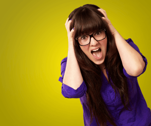 woman-holding-head-in-anguish-image-from-shutterstock