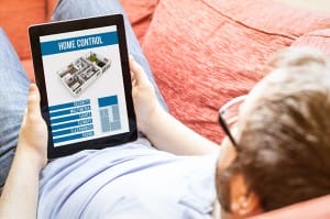 man-holding-tablet-controlling-home-automation-image-from-shutterstock