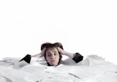 woman-drowning-in-paperwork-image-from-shutterstock
