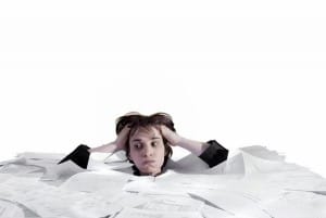 woman-drowning-in-paperwork-image-from-shutterstock