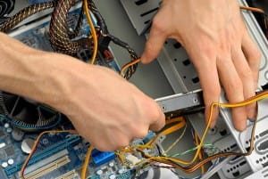 hands-replacing-computer-hard-drive-image-from-shutterstock