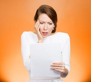 woman-looking-shocked-at-a-report-image-from-shutterstock