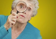 older-woman-looking-through-magnifying-glass-image-from-shutterstock