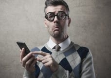 frustrated-man-trying-to-press-smartphone-touchscreen-image-from-shutterstock