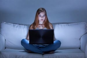 shocked-woman-on-couch-with-laptop-image-from-shutterstock