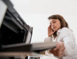 woman-frustrated-looking-at-printer-image-from-shutterstock