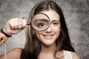 woman-holding-magnifying-glass-over-eye-image-from-shutterstock