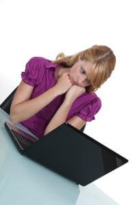young-woman-looking-sadly-at-laptop-screen-image-from-shutterstock
