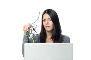 woman-looking-at-computer-cables-image-from-shutterstock