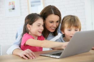 parent-with-kids-looking-at-laptop-computer-image-from-shutterstock